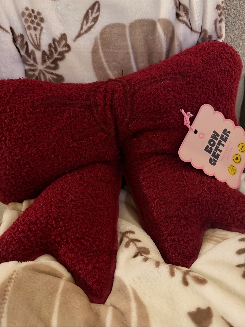 Burgundy bow-shaped cushion
